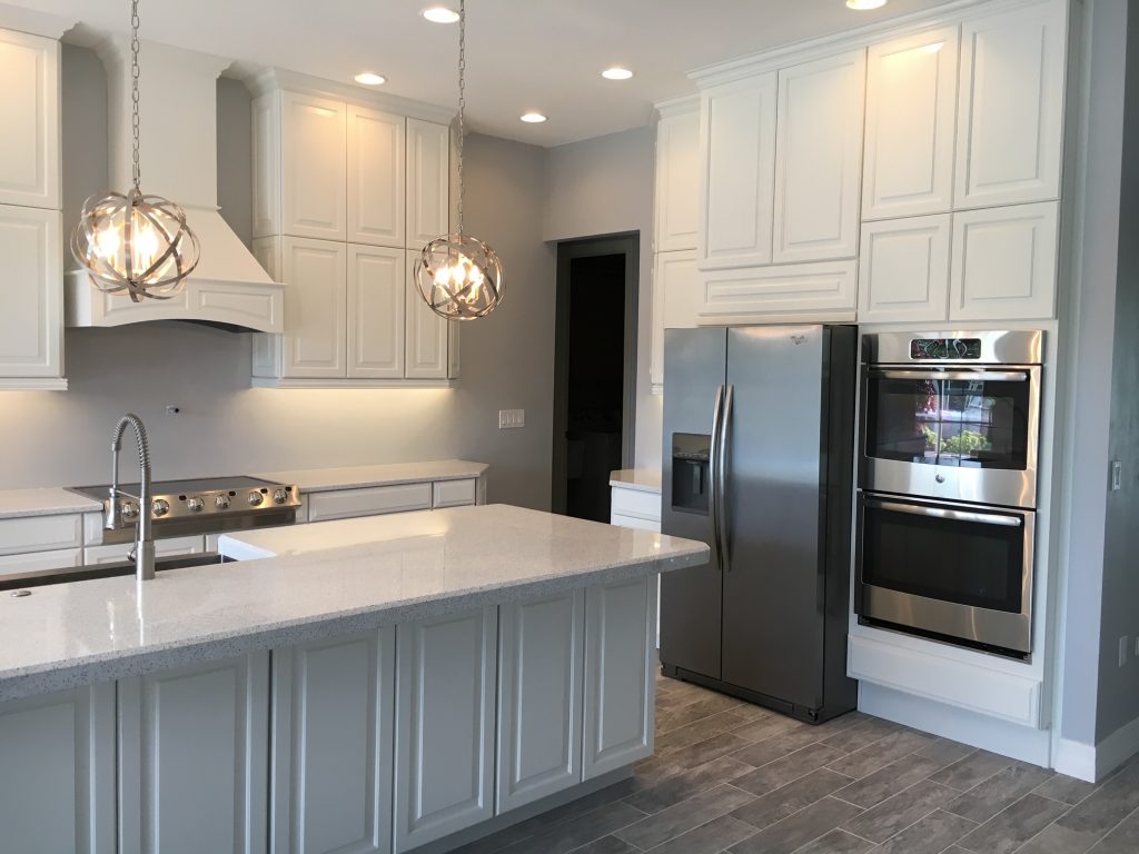 newly renovated kitchen with white granite countertops